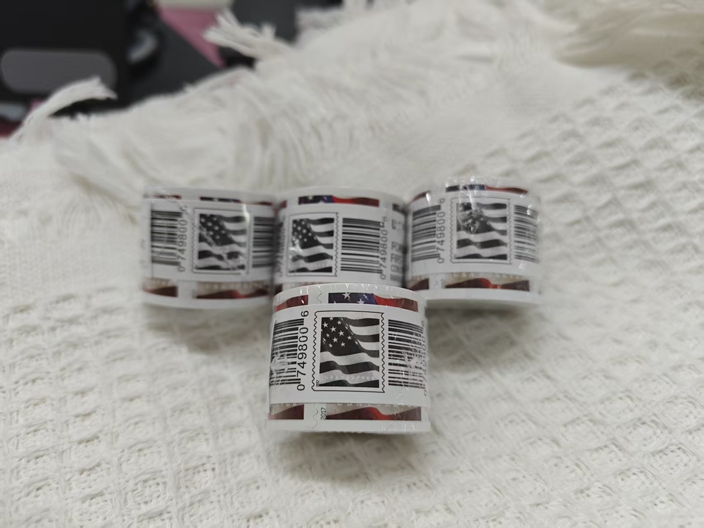 10 rolls of U.S. Postal Service stamps, totaling 1,000 brand new stamps.